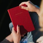 Picture of a woman holding a red spiritual journal