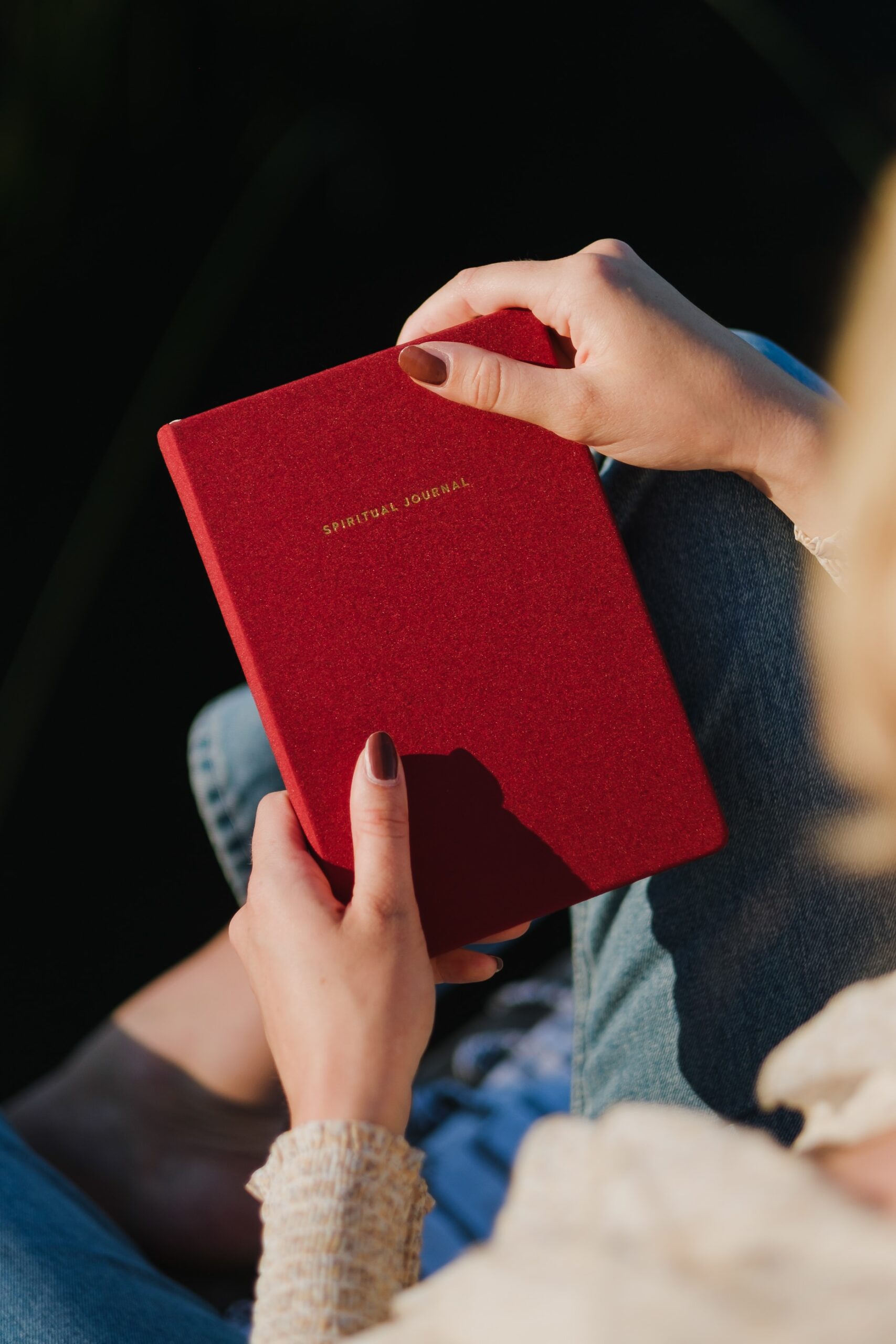 Picture of a woman holding a red spiritual journal
