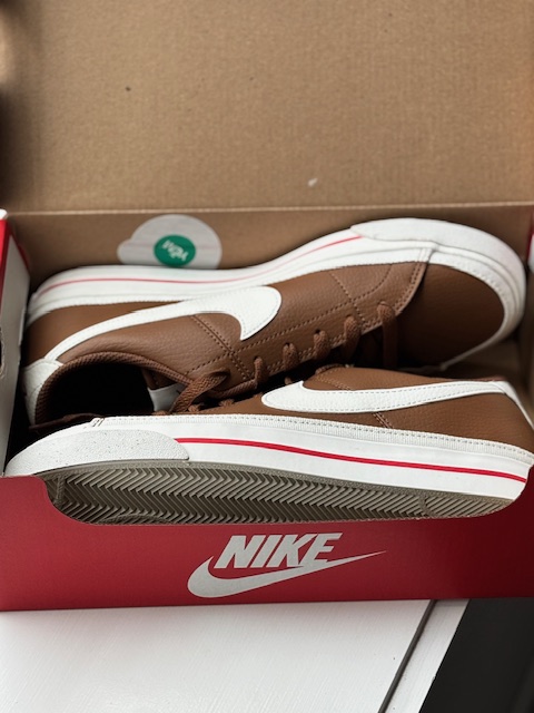 Pair of brown Nike court legacy next nature in Nike shoe box