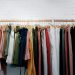 Clothing rack displaying colorful women's trousers and shorts in neutral and classic colors for building a timeless wardrobe.