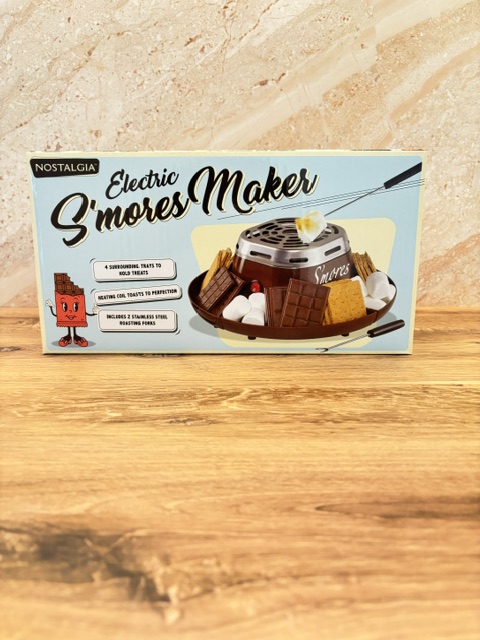 A box for the Nostalgia Electric S’mores Maker for making s’mores at home during family movie night.