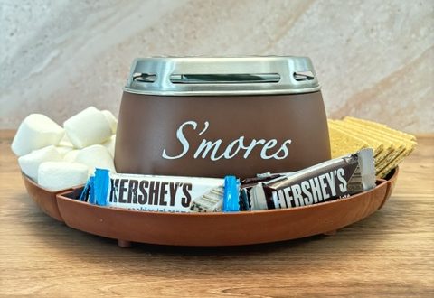S’mores maker surrounded by marshmallows, graham crackers and Hershey’s chocolate bars for a family movie night.