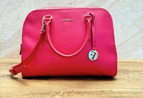 Hot pink Furla structured leather satchel handbag with gold hardware, double handles, detachable shoulder strap, and signature Furla charm.