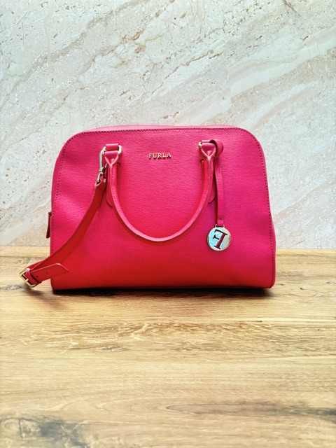 Hot pink Furla structured leather satchel handbag with gold hardware, double handles, detachable shoulder strap, and signature Furla charm.